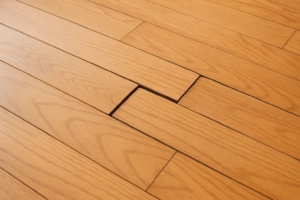 poorly installed hardwood floor showing misaligned boards and gaps